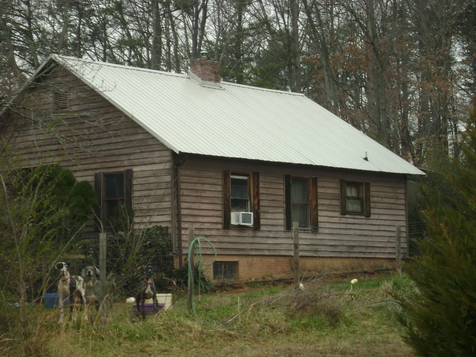White metal roof on an old wood sided farmhouse, from a Metal Roof Installation job in Twin Lakes