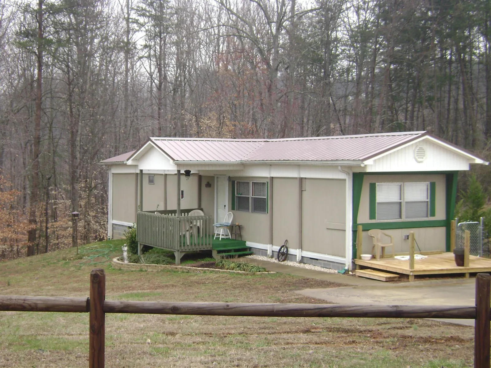 Mauve metal roof on a manufactured home with a new front deck in Twin Lakes